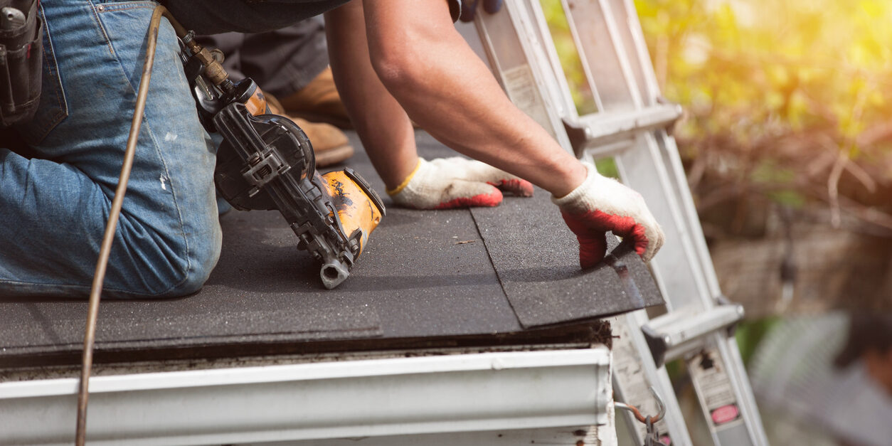 roofing contractor on roof after investing in roofing marketing