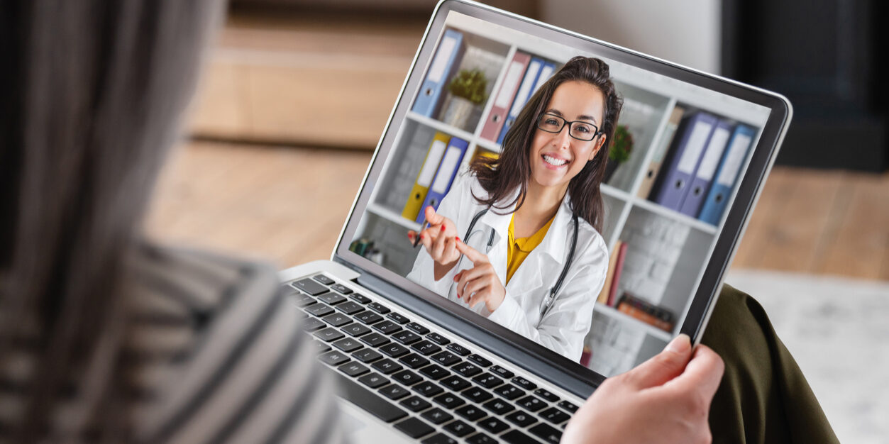 doctor on computer during telehealth marketing session with patient